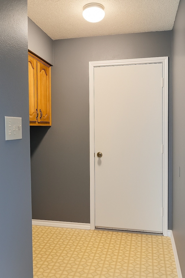 202 Modene Ave, Waxahachie, TX 75165 - laundry room featuring tile patterned floors and a textured ceiling
