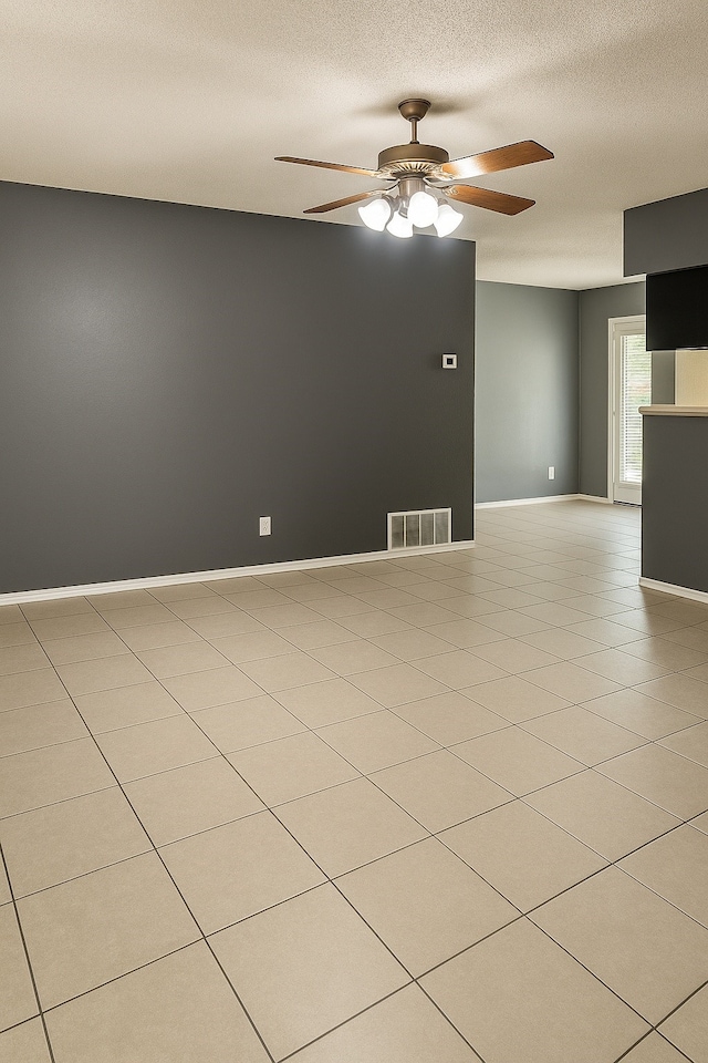 202 Modene Ave, Waxahachie, TX 75165 - unfurnished room with ceiling fan, a textured ceiling, and light tile patterned floors