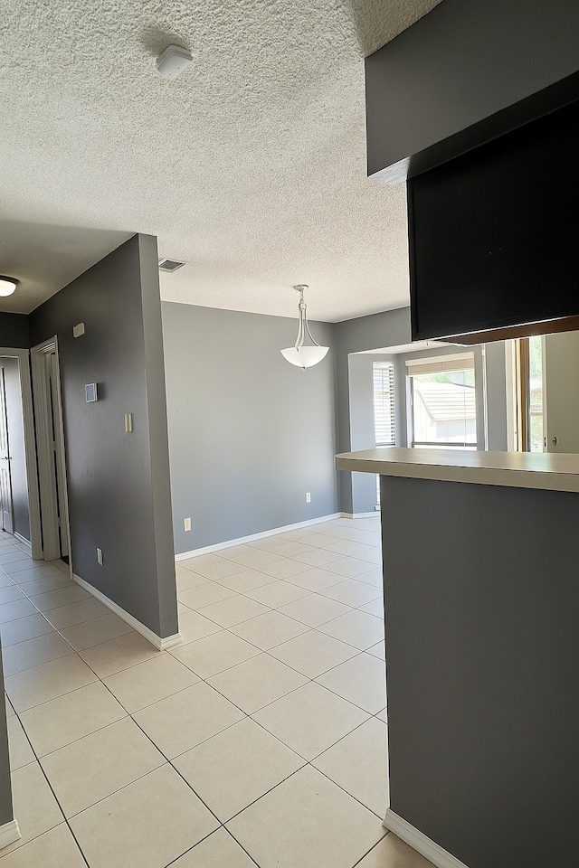 202 Modene Ave, Waxahachie, TX 75165 - spare room featuring a textured ceiling and light tile patterned floors