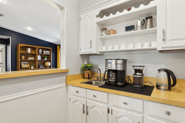 10216 Shadow Way, Dallas, TX 75243 - kitchen with open shelves, white cabinets, and light countertops