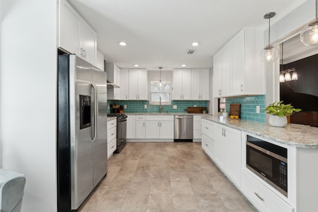 10216 Shadow Way, Dallas, TX 75243 - kitchen with appliances with stainless steel finishes, decorative backsplash, white cabinets, light stone counters, and recessed lighting