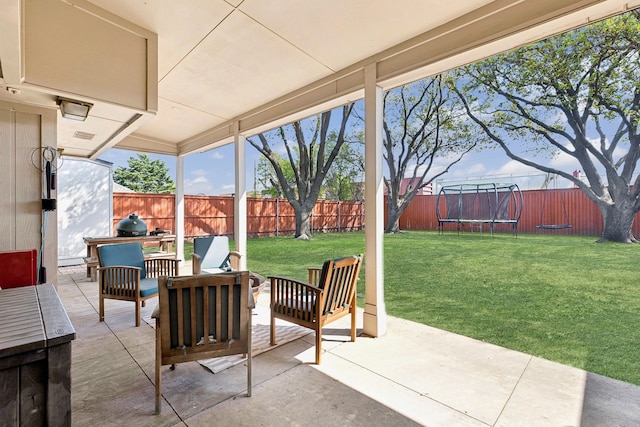 10216 Shadow Way, Dallas, TX 75243 - fenced backyard featuring a trampoline, a patio, and an outdoor hangout area