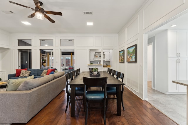10216 Shadow Way, Dallas, TX 75243 - dining area with a ceiling fan, dark wood-style floors, and a decorative wall