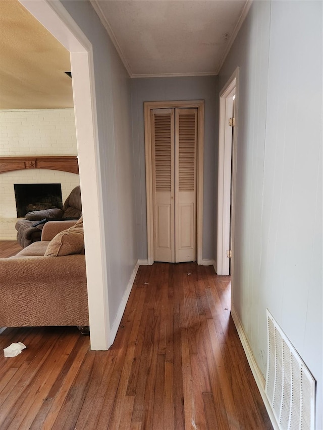1000 Harrison St, Commerce, TX 75428 - hallway featuring hardwood / wood-style floors and crown molding