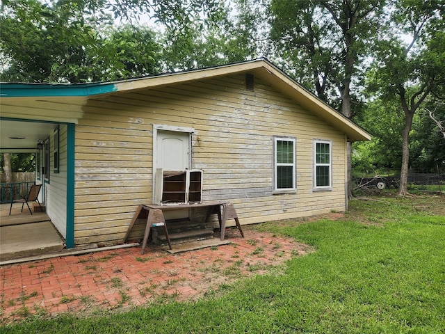 1000 Harrison St, Commerce, TX 75428 - rear view of property with a yard and a patio