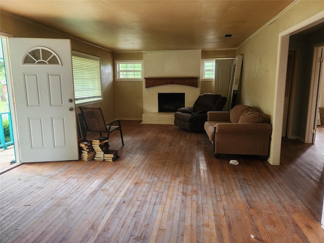 1000 Harrison St, Commerce, TX 75428 - living area with hardwood / wood-style floors and a fireplace