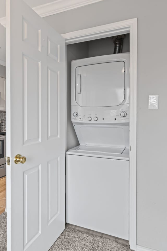 825 W Harwood Rd Unit A, Hurst, TX 76054 - laundry room featuring stacked washer / drying machine