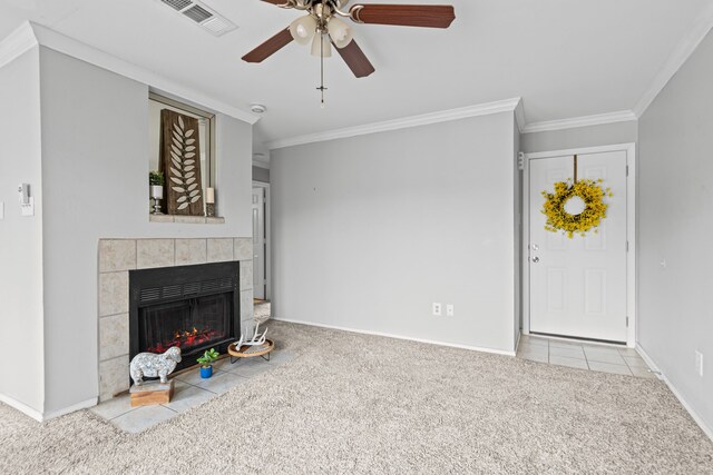 825 W Harwood Rd Unit A, Hurst, TX 76054 - unfurnished living room with carpet, ornamental molding, ceiling fan, a tile fireplace, and tile patterned floors