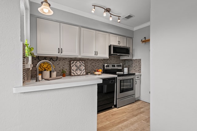 825 W Harwood Rd Unit A, Hurst, TX 76054 - kitchen with appliances with stainless steel finishes, light countertops, tasteful backsplash, ornamental molding, and light wood-type flooring