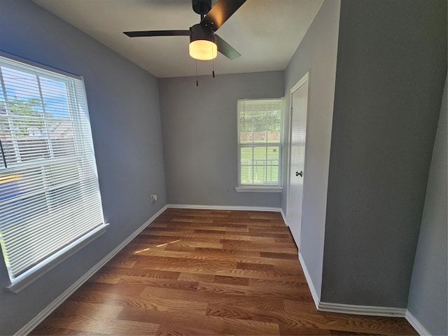511 W Lake St, Krum, TX 76249 - empty room featuring plenty of natural light, wood finished floors, and a ceiling fan