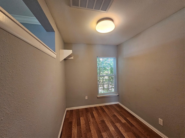 511 W Lake St, Krum, TX 76249 - spare room with dark wood finished floors and a textured wall
