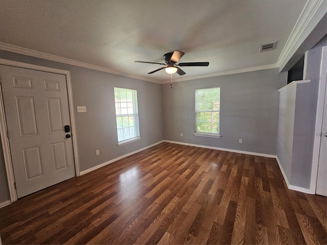 511 W Lake St, Krum, TX 76249 - empty room featuring plenty of natural light, dark wood-style floors, a ceiling fan, and crown molding