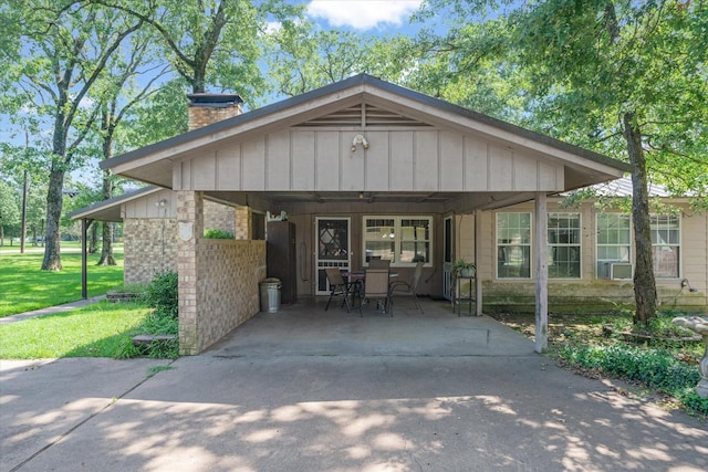 180 Vz County Road 4202, Canton, TX 75103 - view of front facade featuring a chimney, board and batten siding, a front yard, and a carport