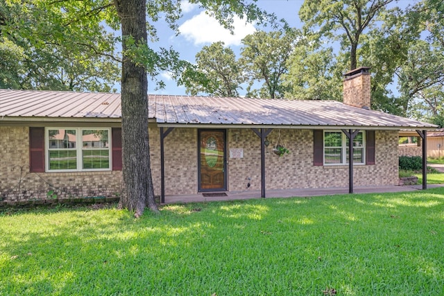 180 Vz County Road 4202, Canton, TX 75103 - rear view of house featuring a yard, brick siding, a chimney, and a metal roof