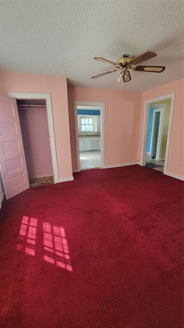 401 Lawrence Ave, Terrell, TX 75160 - unfurnished bedroom with a textured ceiling, carpet floors, ceiling fan, and a closet
