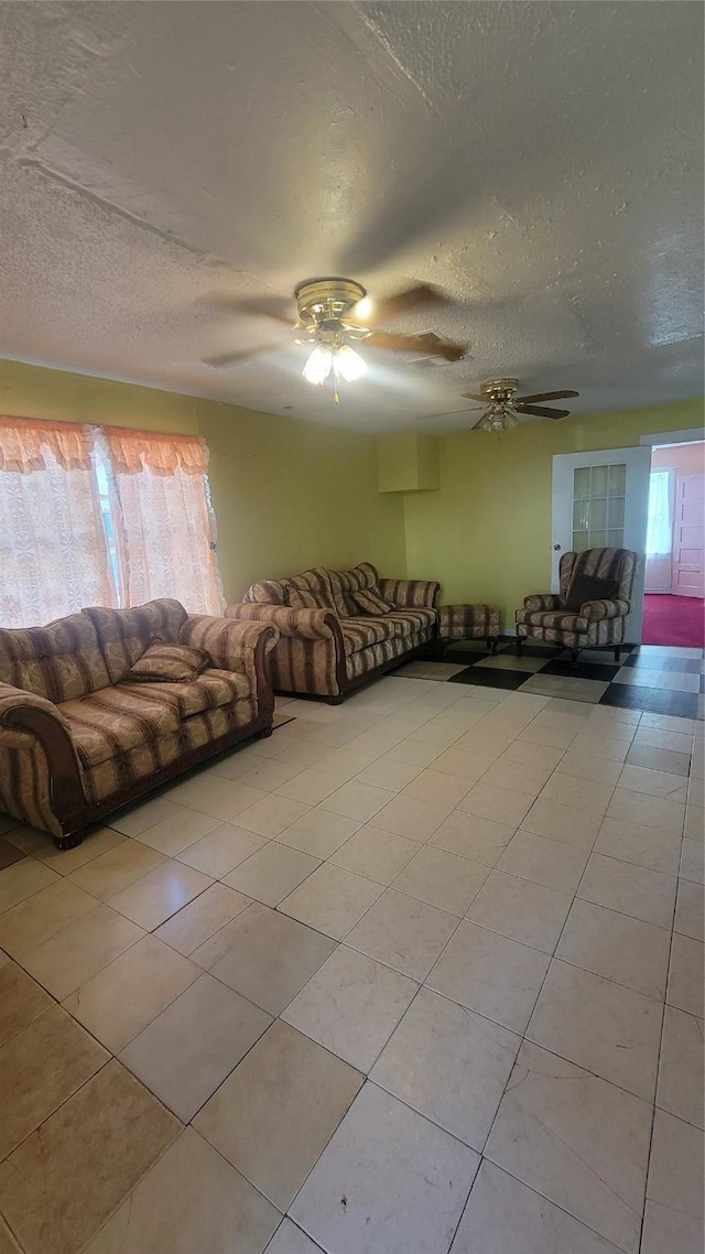 401 Lawrence Ave, Terrell, TX 75160 - unfurnished living room with light tile patterned flooring, a textured ceiling, and a ceiling fan