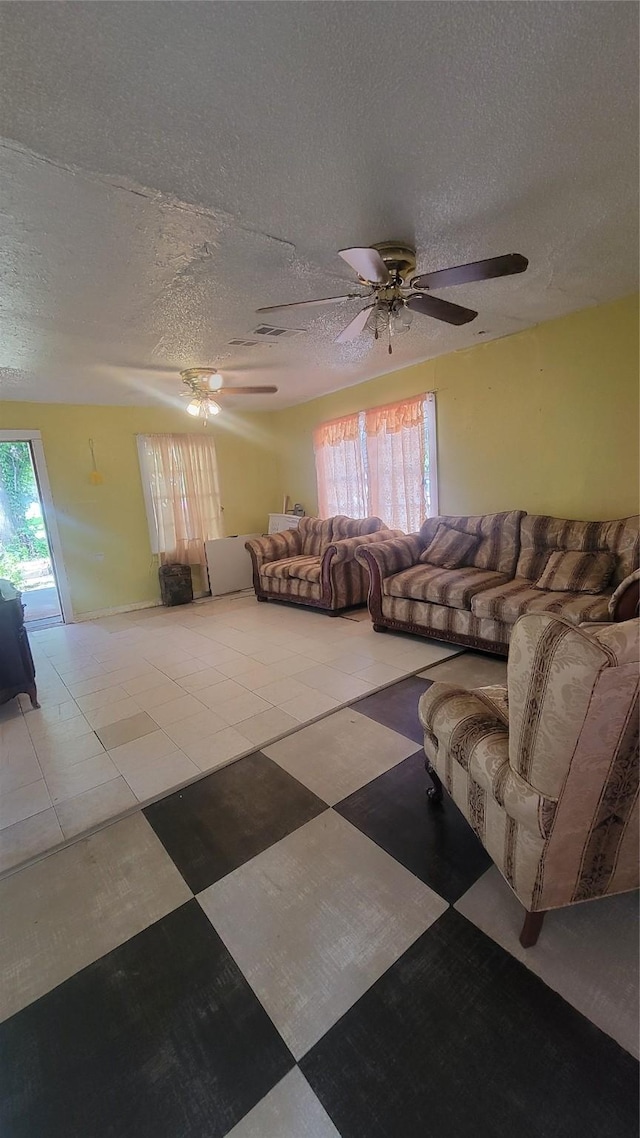 401 Lawrence Ave, Terrell, TX 75160 - living room featuring ceiling fan, a textured ceiling, and tile patterned floors