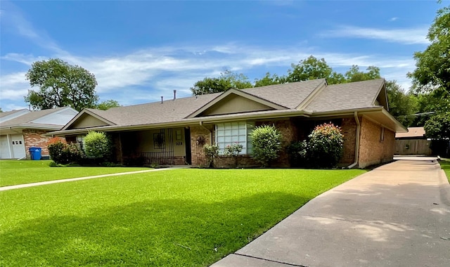 1410 Yarborough Dr, Sherman, TX 75092 - ranch-style home with brick siding, a front yard, roof with shingles, and a porch