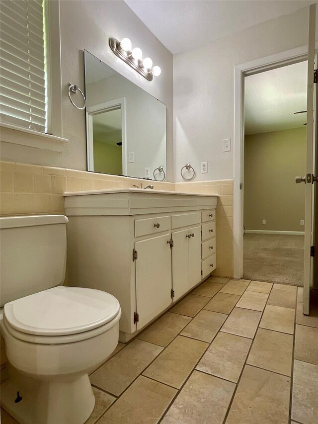 1410 Yarborough Dr, Sherman, TX 75092 - bathroom with tile walls, vanity, tile patterned flooring, and a wainscoted wall