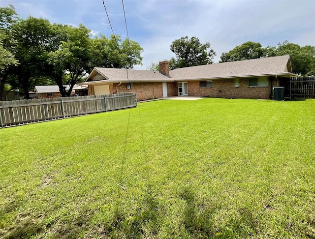 1410 Yarborough Dr, Sherman, TX 75092 - back of property featuring a chimney, brick siding, and a patio area