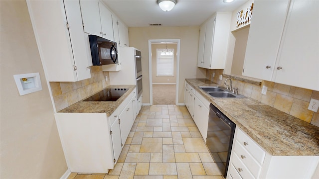 1410 Yarborough Dr, Sherman, TX 75092 - kitchen featuring black appliances, decorative backsplash, white cabinets, and light stone finish floors