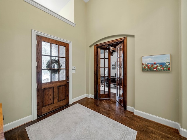 3309 Laurel Fork Dr, Mckinney, TX 75070 - foyer entrance featuring dark wood-style floors, french doors, and arched walkways
