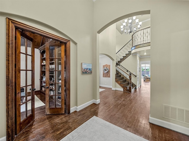 3309 Laurel Fork Dr, Mckinney, TX 75070 - foyer entrance with arched walkways, wood finished floors, a high ceiling, french doors, and stairs