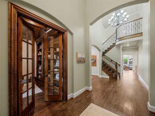 3309 Laurel Fork Dr, Mckinney, TX 75070 - foyer with arched walkways, wood finished floors, stairway, crown molding, and a chandelier