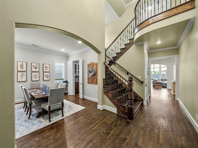 3309 Laurel Fork Dr, Mckinney, TX 75070 - dining space with arched walkways, wood finished floors, stairs, crown molding, and recessed lighting