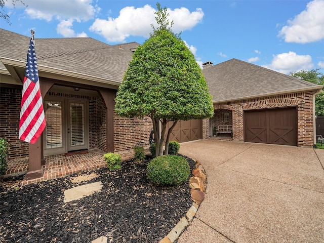 3309 Laurel Fork Dr, Mckinney, TX 75070 - view of front of property featuring roof with shingles, brick siding, an attached garage, and driveway