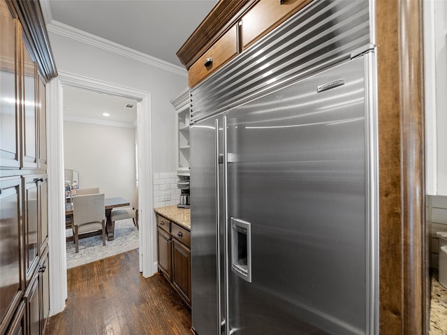 3309 Laurel Fork Dr, Mckinney, TX 75070 - kitchen featuring stainless steel built in fridge, ornamental molding, dark wood finished floors, backsplash, and light stone countertops
