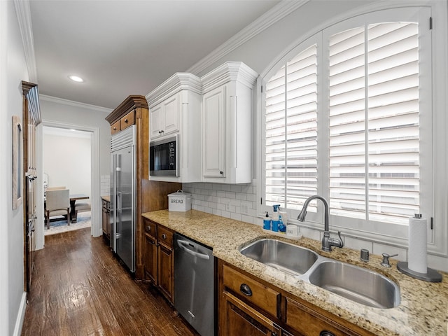 3309 Laurel Fork Dr, Mckinney, TX 75070 - kitchen featuring built in appliances, dark wood-style flooring, white cabinets, light stone countertops, and crown molding