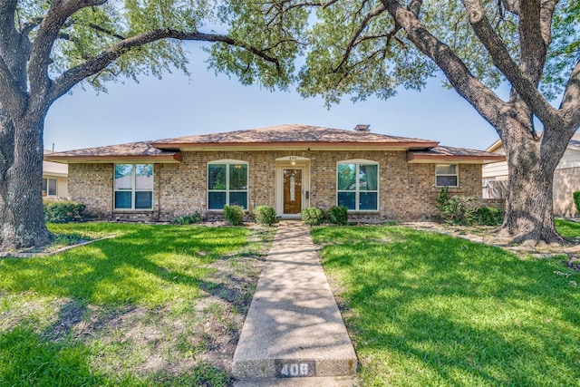 406 Los Santos Dr, Garland, TX 75043 - ranch-style home featuring a front yard and brick siding