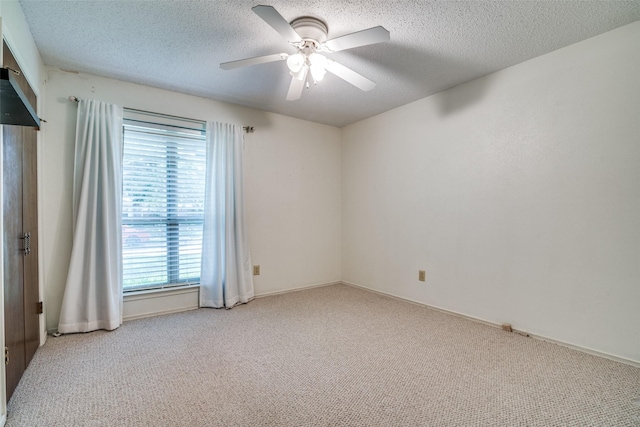 406 Los Santos Dr, Garland, TX 75043 - carpeted spare room with a textured ceiling and a ceiling fan