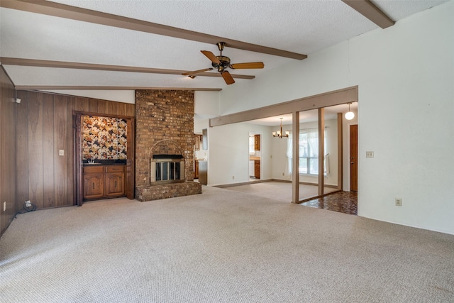 406 Los Santos Dr, Garland, TX 75043 - unfurnished living room with beamed ceiling, a ceiling fan, a chandelier, carpet floors, and a fireplace