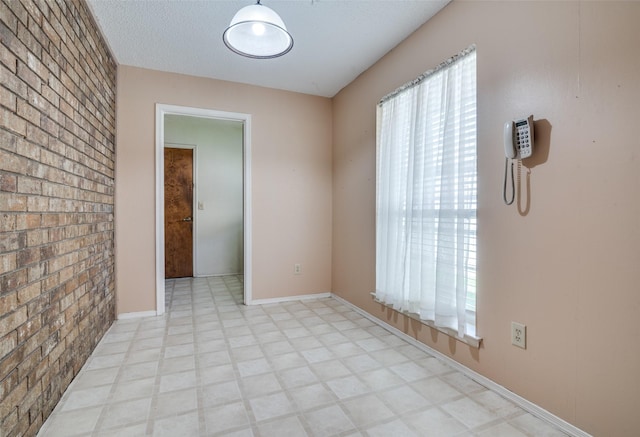 406 Los Santos Dr, Garland, TX 75043 - spare room featuring light floors and baseboards