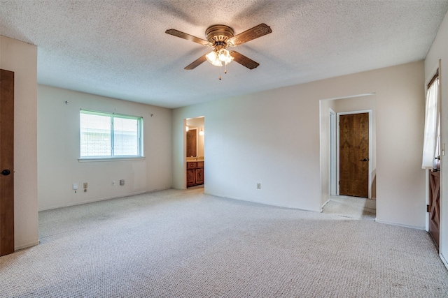 406 Los Santos Dr, Garland, TX 75043 - unfurnished bedroom with light colored carpet, a textured ceiling, and ensuite bathroom