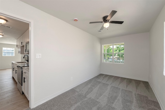 3924 Dismount St, Dallas, TX 75211 - empty room featuring healthy amount of natural light, ceiling fan, a smoke detector, and light carpet