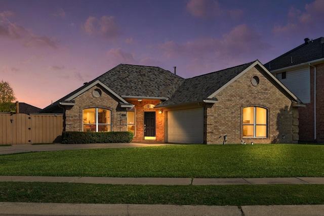 4901 Marcus Dr, Flower Mound, TX 75028 - french country style house with brick siding, an attached garage, a gate, driveway, and a shingled roof