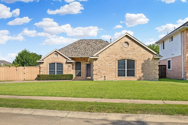4901 Marcus Dr, Flower Mound, TX 75028 - view of front facade featuring brick siding, a gate, and a shingled roof
