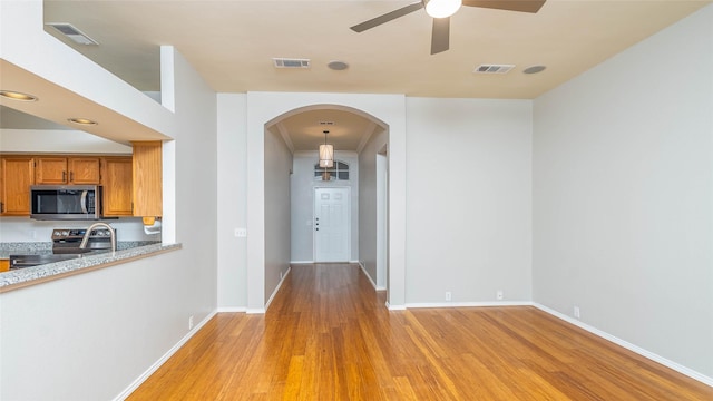 2512 Woodhaven Dr, Flower Mound, TX 75028 - corridor with arched walkways and light wood finished floors