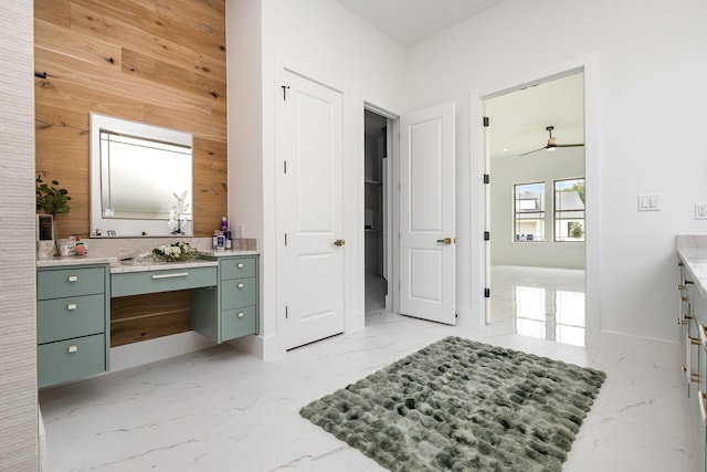 1022 Bow St, Rockwall, TX 75087 - bathroom with wooden walls, vanity, ceiling fan, and marble finish flooring