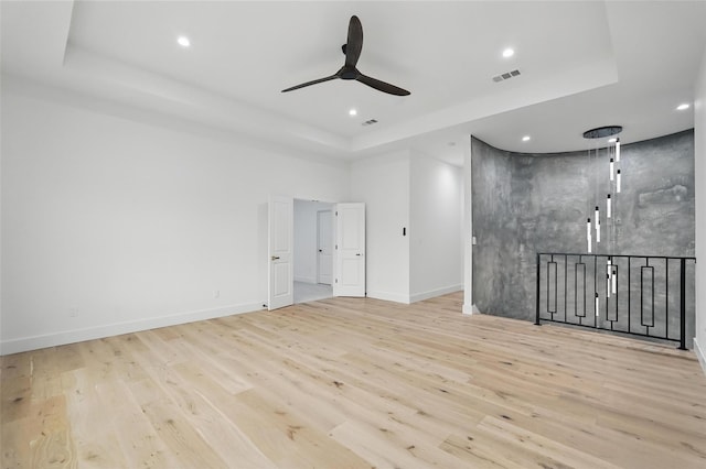 1022 Bow St, Rockwall, TX 75087 - empty room featuring a raised ceiling, wood finished floors, a ceiling fan, and recessed lighting