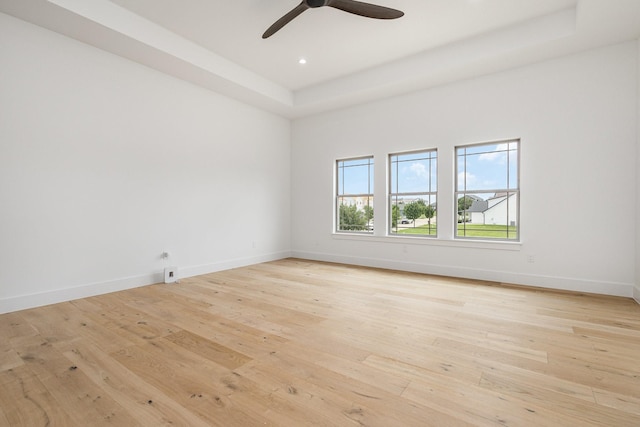 1022 Bow St, Rockwall, TX 75087 - unfurnished room with light wood finished floors, ceiling fan, a raised ceiling, and recessed lighting