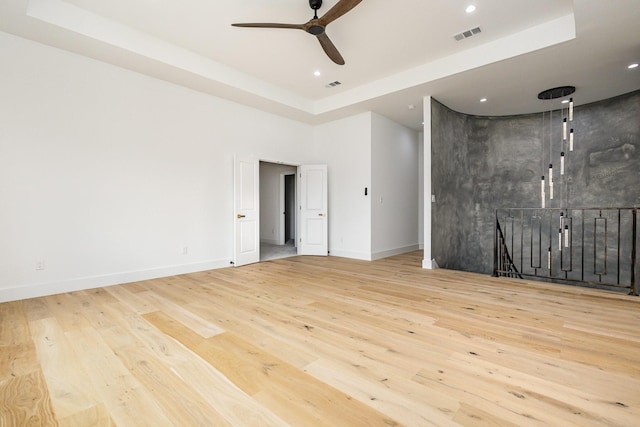 1022 Bow St, Rockwall, TX 75087 - spare room featuring a tray ceiling, wood finished floors, ceiling fan, and recessed lighting