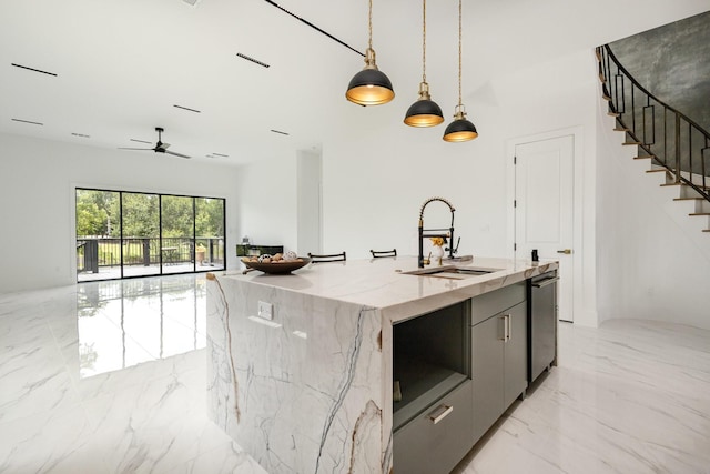 1022 Bow St, Rockwall, TX 75087 - kitchen with light marble finish flooring, modern cabinets, pendant lighting, light stone counters, and open floor plan
