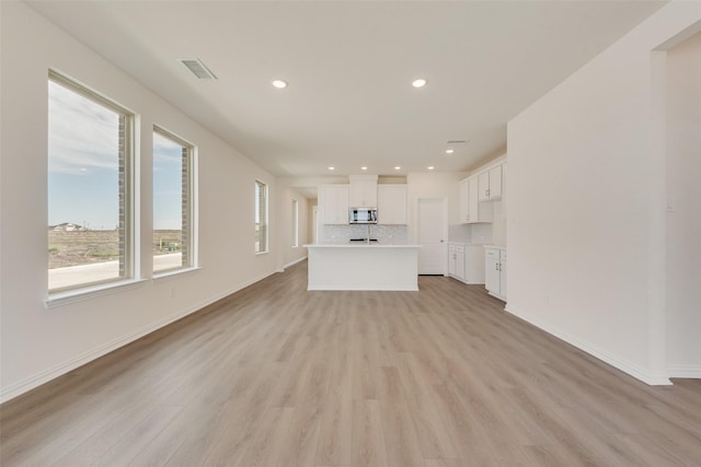 1502 Salem Dr, Forney, TX 75126 - unfurnished living room with light wood-type flooring and recessed lighting