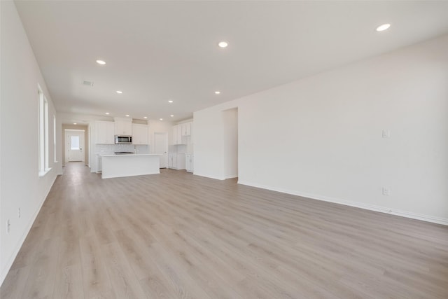 1502 Salem Dr, Forney, TX 75126 - unfurnished living room featuring light wood finished floors and recessed lighting