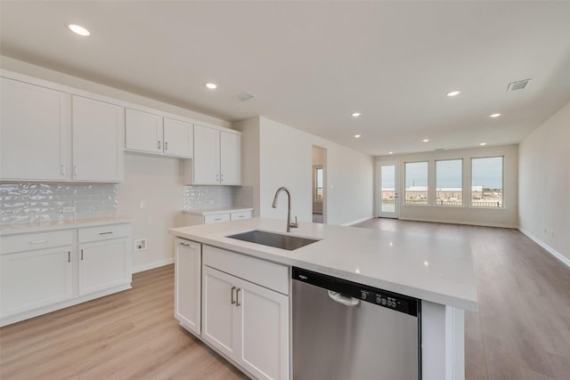1502 Salem Dr, Forney, TX 75126 - kitchen with stainless steel dishwasher, light wood finished floors, decorative backsplash, white cabinets, and open floor plan