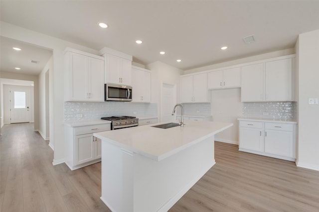1502 Salem Dr, Forney, TX 75126 - kitchen featuring appliances with stainless steel finishes, white cabinetry, light wood-style floors, backsplash, and recessed lighting